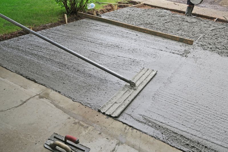 Worker trowelling a freshly resurfaced driveway
