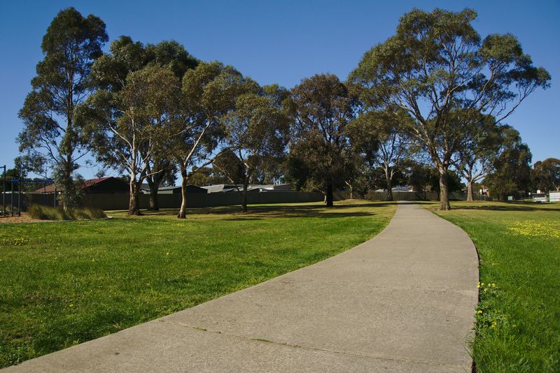 Clean, newly poured concrete footpath alongside a residential property